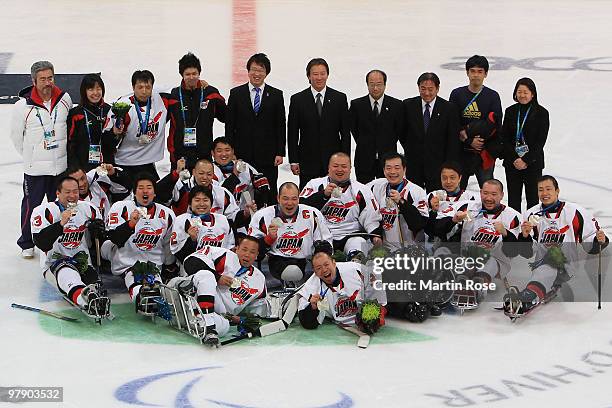 Team Japan celebrate their silver-medal win after being defeated 2-0 by the United States during the Ice Sledge Hockey Gold Medal Game on day nine of...