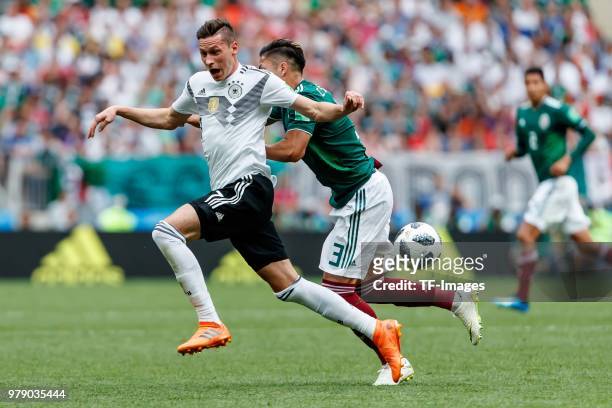 Julian Draxler of Germany and Carlos Salcedo of Mexico battle for the ball during the 2018 FIFA World Cup Russia group F match between Germany and...