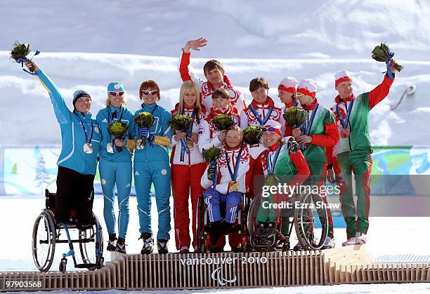 Silver medal winners from Belarus , gold medal winners from Russia, and bronze medal winner from Belarus wave to the crowd after the medal ceremony...