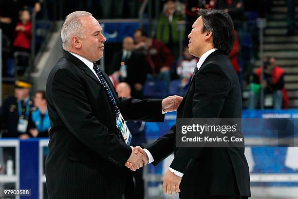 Ray Maluta, head coach of the United States, and Kojin Nakakita, head coach of Japan, shake hands after the United States defeated Japan 2-0 during...