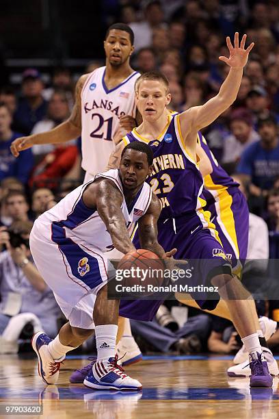 Sherron Collins of the Kansas Jayhawks passes the ball against Marc Sonnen of the Northern Iowa Panthers during the second round of the 2010 NCAA...