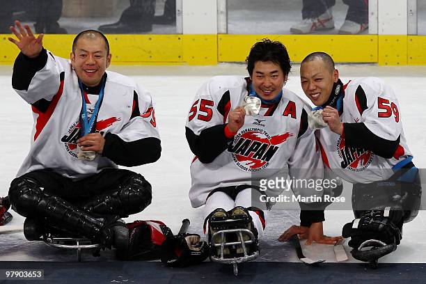 Goalkeeper Mitsuru Nagase, Kazuhiro Takahashi and Noritaka Ito of Japan celebrate their silver-medal win after being defeated 2-0 by the United...