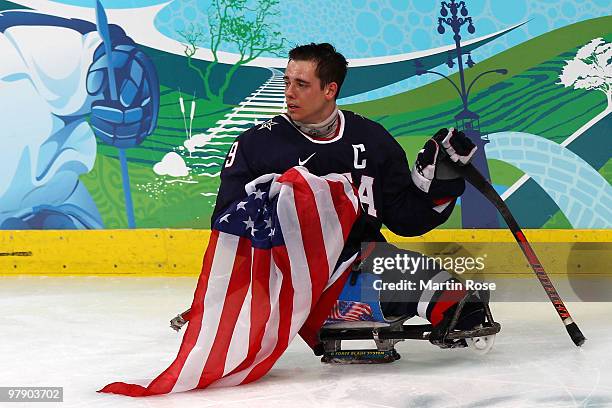 Andy Yohe of the United States celebrates defeating Japan 2-0 during the Ice Sledge Hockey Gold Medal Game between the United States and Japan on day...