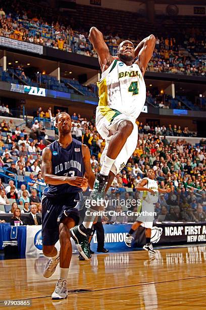 Quincy Acy of the Baylor Bears dunks the ball over Keyon Carter of the Old Dominion University Monarchs during the second round of the 2010 NCAA...
