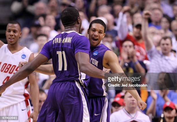 Forward Matthew Bryan-Amaning and Abdul Gaddy of the Washington Huskies celebrates after a play against the New Mexico Lobos during the second round...
