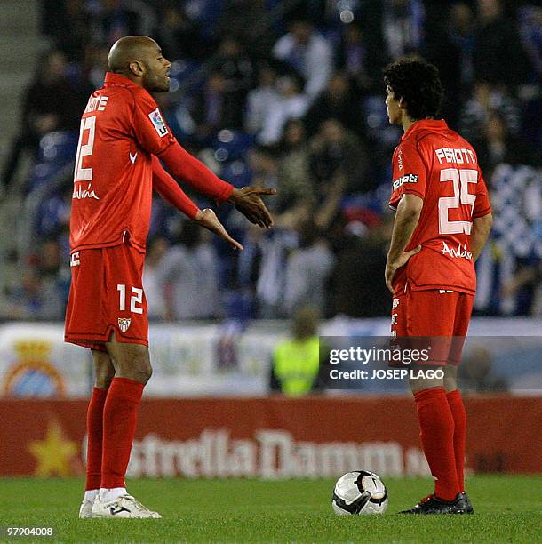 Sevilla's Malian forward Frederic Kanoute speaks with teammate Argentinian midfielder Diego Perotti during their Spanish League football match...