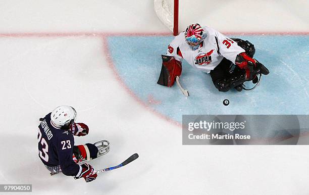 Goalkeeper Mitsuru Nagase of Japan makes a save against Joe Howard of the United States during the Ice Sledge Hockey Gold Medal Game on day nine of...