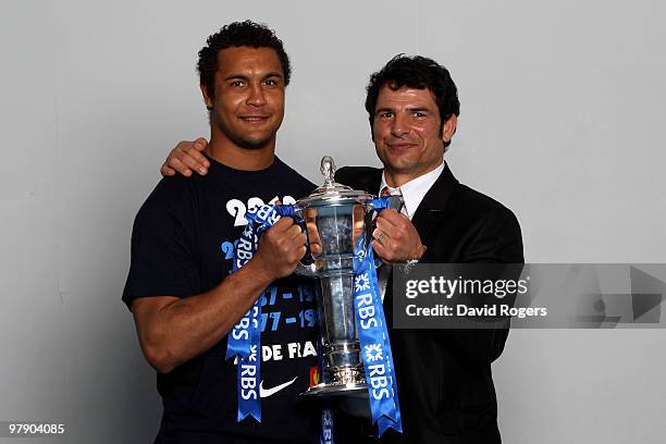 Thierry Dusautoir the captain of France and Marc Lievremont the head coach of France celebrate with the trophy after winning the Grand Slam and...