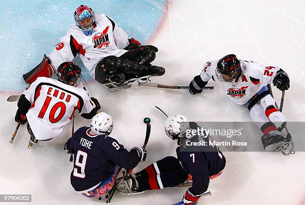 Goalkeeper Mitsuru Nagase, Takayuki Endo and Satoru Sudo of Japan defend the net from Andy Yohe and Taylor Lipsett of the United States during the...