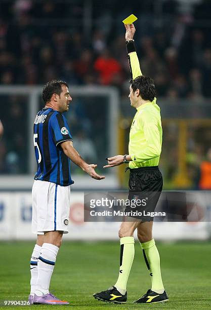 The referee Antonio Damato shows a yellow card to Dejan Stankavic of FC Internazionale Milano during the Serie A match between US Citta di Palermo...