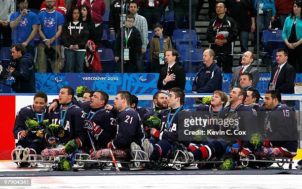 Team USA sings the National Anthem as they celebrate their 2-0 win over Japan during the Ice Sledge Hockey Gold Medal Game between the United States...
