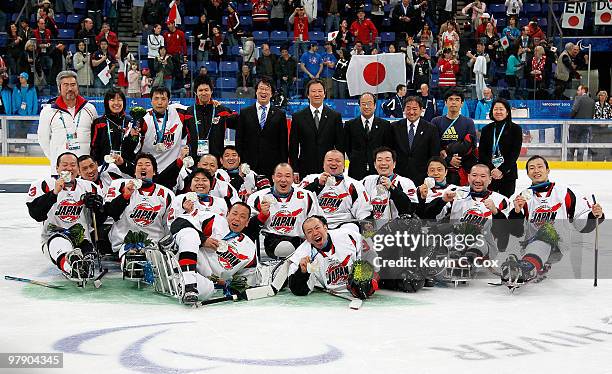 Team Japan celebrates their Silver Medal after their 2-0 loss to the United States during the Ice Sledge Hockey Gold Medal Game between the United...