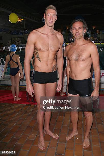 Alain Bernard and Paul Belmondo pose during the launch of the third charity water night 2010 at Georges Vallerey swimming pool on March 20, 2010 in...