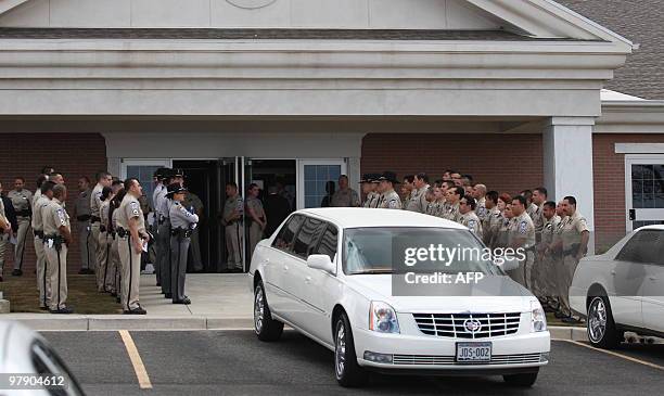 Members of the Sherrif Office of El Paso, Texas, escort a car where the relatives of sherrif Arthur Redelfs and his wife Lesley Ann carry their ashes...