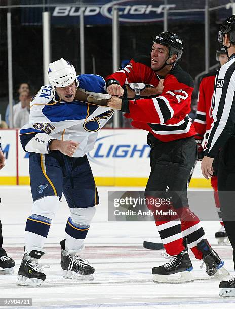 Cam Janssen of the St. Louis Blues and Pierre-Luc Letourneau Leblond of the New Jersey Devils trade punches during a first period fight at the...