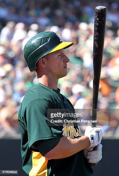 Mark Ellis of the Oakland Athletics warms up on deck during the MLB spring training game against the San Francisco Giants at Phoenix Municipal...