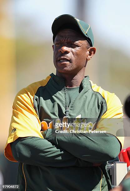 Special instructor Rickey Henderson of the Oakland Athletics sits during the MLB spring training game against the San Francisco Giants at Phoenix...