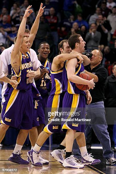 Marc Sonnen, Kwadzo Ahelegbe, Ali Farokhmanesh and Johnny Moran of the Northern Iowa Panthers celebrate after they won 69-67 against the Kansas...