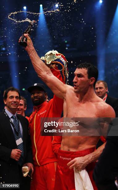 Wladimir Klitschko of Ukraine celebrates with a bottle of beer after winning his WBO Heavyweight World Championship fight against Eddie Chambers of...