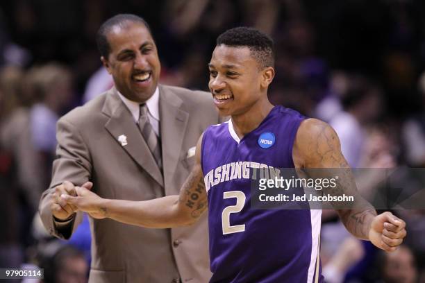 Guard Isaiah Thomas and head coach Lorenzo Romar of the Washington Huskies celebrate after their 82-64 win over the New Mexico Lobos in the second...