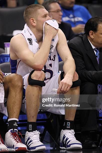 Cole Aldrich of the Kansas Jayhawks looks on dejected from the bench against the Northern Iowa Panthers during the second round of the 2010 NCAA...