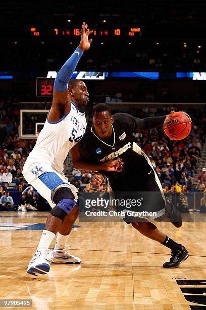 Al-Farouq Aminu of the Wake Forest Demon Deacons drives the ball around Patrick PAtterson of the Kentucky Wildcats during the second round of the...