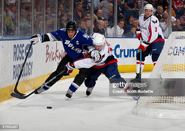 Vincent Lecavalier of the Tampa Bay Lightning battles for the puck against Eric Belanger of the Washington Capitals during the first period at the...