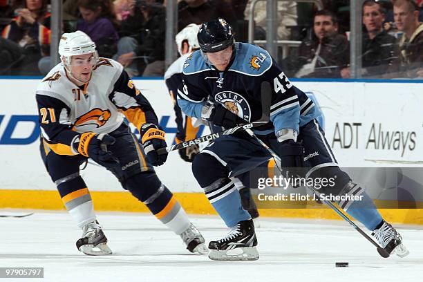 Dmitry Kulikov of the Florida Panthers skates with the puck against Drew Stafford of the Buffalo Sabres at the BankAtlantic Center on March 20, 2010...