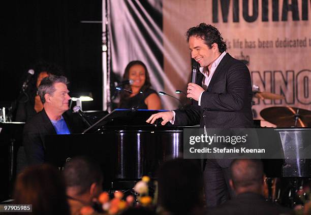 Producer/musician David Foster and Remigio Pereira of The Canadian Tenors perform onstage during the Celebrity Fight Night XVI Founder's Dinner held...