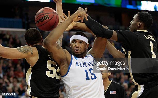 Demarcus Cousins of the Kentucky Wildcats battles Tony Woods and Al-Farouq Aminu the Wake Forest Demons Deacons during the second round of the 2010...