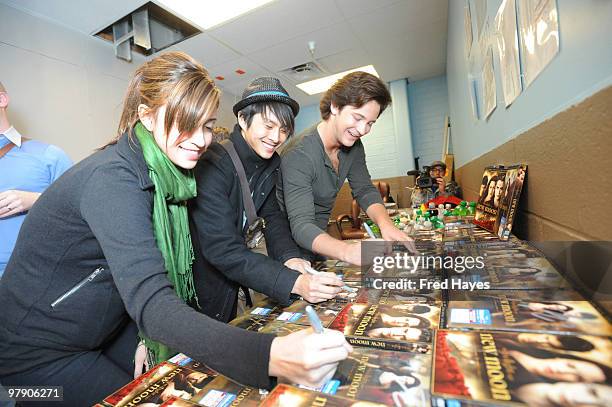 Actors Christian Seratos, Justin Chon and Michael Welch autograph dvds at the The Twilight Saga: New Moon DVD Release Party on March 19, 2010 at the...