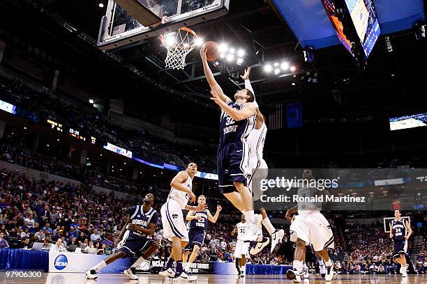 Jimmer Fredette of the Brigham Young Cougars drives for a shot attempt against the Kansas State Wildcats during the second round of the 2010 NCAA...