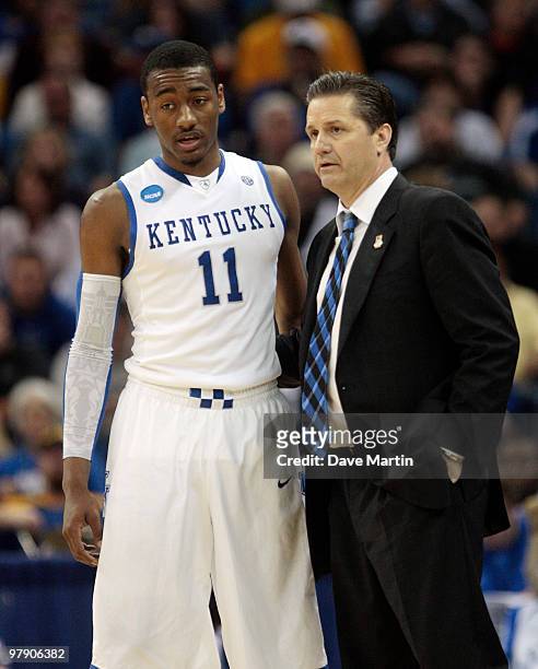 Coach John Calipari of the Kentucky Wildcats talks with player John Wall during the second round of the 2010 NCAA men's basketball tournament against...