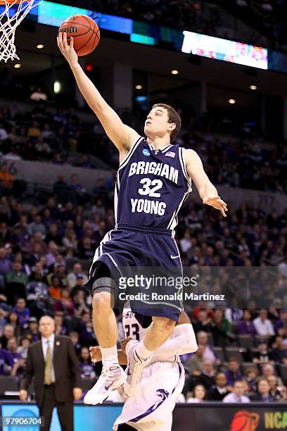 Jimmer Fredette of the Brigham Young Cougars drives for a shot attempt against the Kansas State Wildcats during the second round of the 2010 NCAA...
