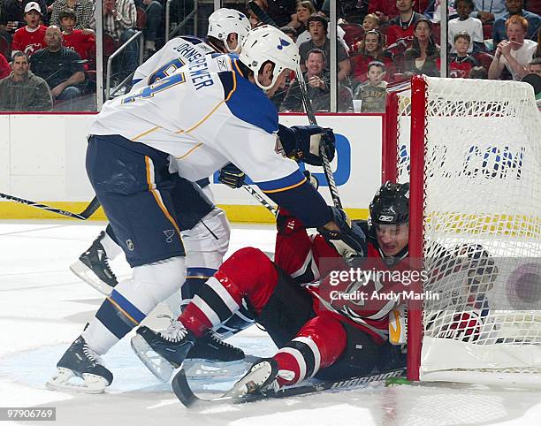 Jamie Langenbrunner of the New Jersey Devils receives a two minute interference penalty after being knocked into Ty Conklin of the St. Louis Blues by...