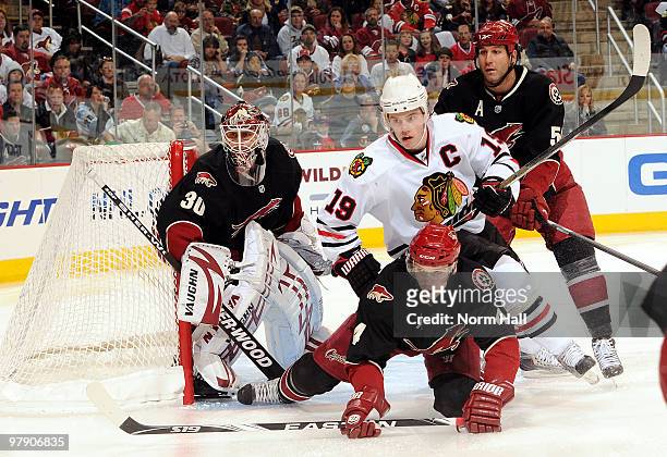 Zbynek Michalek of the Phoenix Coyotes and Jonathan Toews of the Chicago Blackhawks look for the puck in front of Ilya Bryzgalov of the Phoenix...