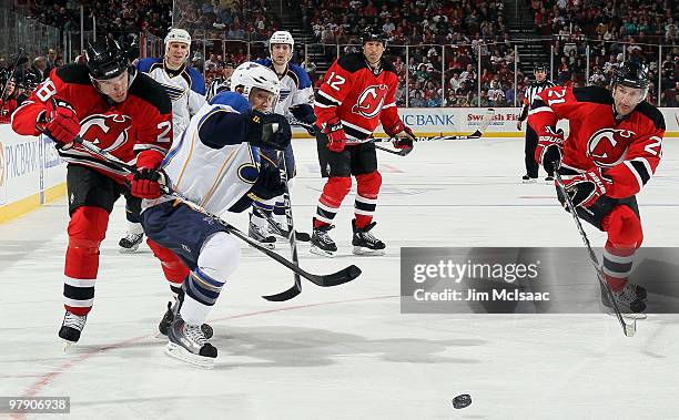 Martin Skoula and Rob Niedermayer of the New Jersey Devils defend against Andy McDonald of the St. Louis Blues at the Prudential Center on March 20,...