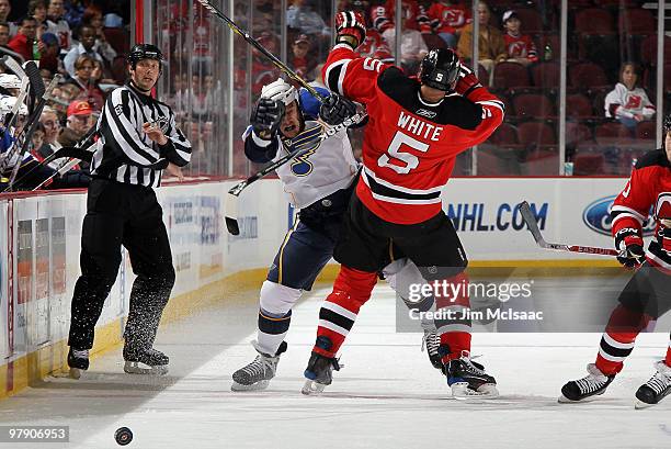 Cam Janssen of the St. Louis Blues collides with Colin White of the New Jersey Devils at the Prudential Center on March 20, 2010 in Newark, New...