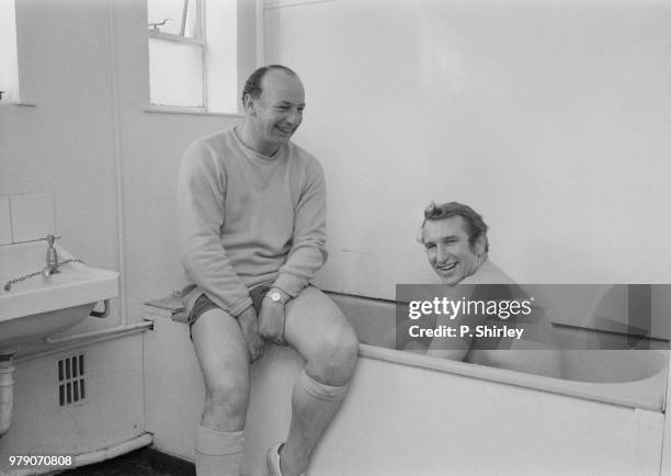 English soccer player and manager of Bristol City FC Alan Dicks taking a bath while English soccer player and Bristol City FC youth coach John...