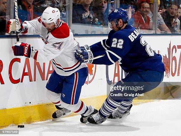 Francois Beauchemin of the Toronto Maple Leafs battles for the puck with Brian Gionta of the Montreal Canadiens during game action March 20, 2010 at...