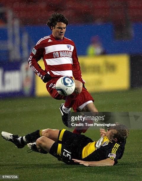 Defenseman Heath Pearce of FC Dallas controls the ball against midfielder Kevin Burns of the Columbus Crew during a preseason game at Pizza Hut Park...
