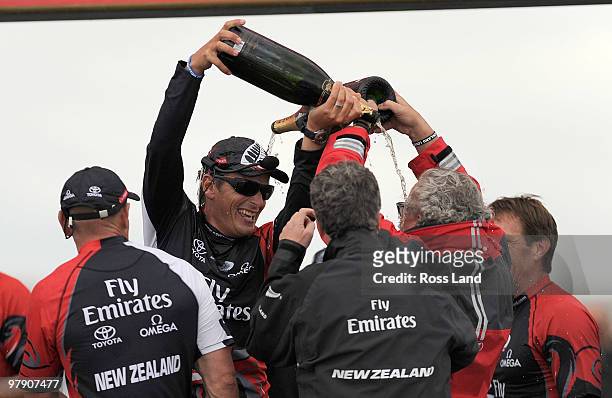 Emirates Team New Zealand skipper Dean Barker and Louis Vuitton media center coordinator Bruno Trouble douse each other with Champagne after Barker...