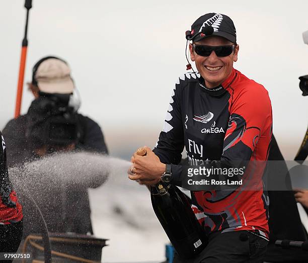 Emirates Team New Zealand skipper Dean Barker sprays Champagne after crossing the line ahead of Mascalzone Latino Audi Team from Italy to win the...