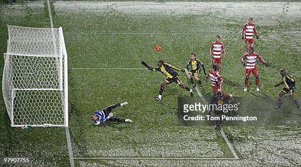 Goal keeper Kevin Hartman of FC Dallas blocks a shot on goal against the Columbus Crew during a preseason game in the snow at Pizza Hut Park on March...