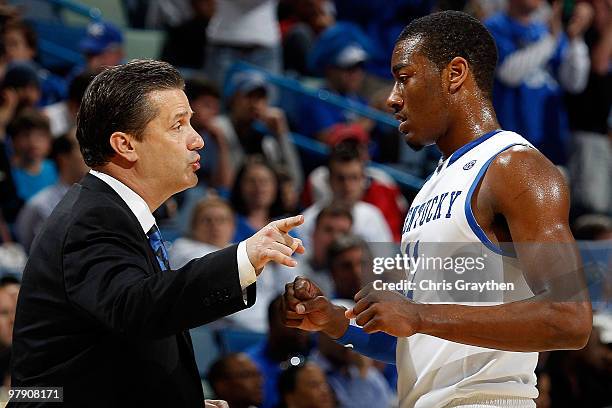 Head coach John Calipari talks with John Wall of the Kentucky Wildcats talks with his team during a timeout against the Wake Forest Demon Deacons...