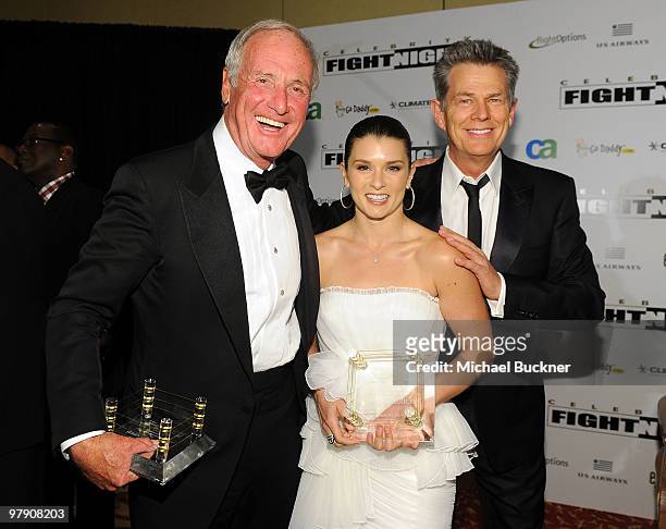 Producer Jerry Weintraub, race car driver Danica Patrick, and producer/musician David Foster pose during Celebrity Fight Night XVI on March 20, 2010...