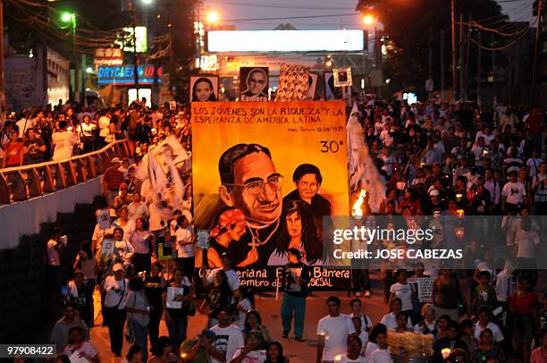 Catholic faitfuls participate during a procession to conmemorate the 30 anniversary of the murder of Archbishop Oscar Arnulfo Romero in San Salvador,...