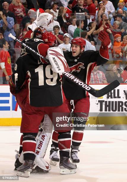 Keith Yandle and Shane Doan of the Phoenix Coyotes celebrate with goaltender Ilya Bryzgalov after defeating the Chicago Blackhawks in an overtime...