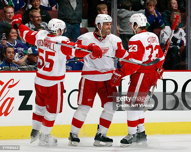 Todd Bertuzzi of the Detroit Red Wings celebrates his goal with teammates Niklas Kronwall and Brad Stuart during their game against the Vancouver...
