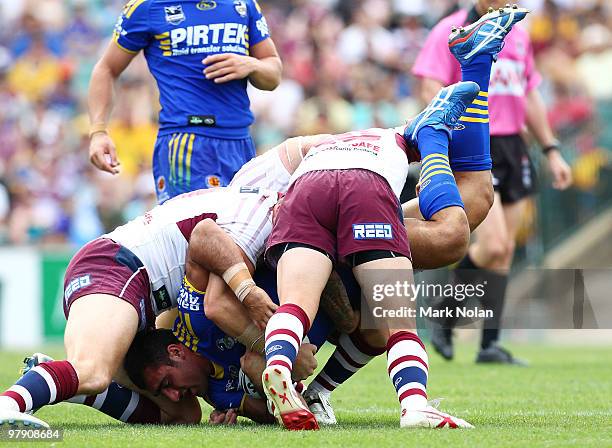 Tim Mannah of the Eels is tackled during the round two NRL match between the Parramatta Eels and the Manly Sea Eagles at Parramatta Stadium on March...